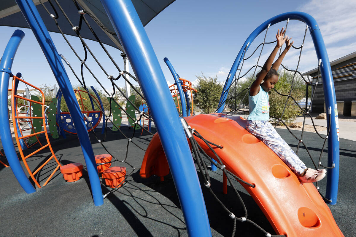 Juju Lowe , 7 of Las Vegas plays on a slide at Baker Park, Friday, Oct. 8, 2021, in Las Vegas. ...