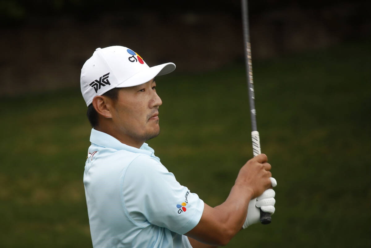 Sung Kang of South Korea watches his tee shot on the 11th hole during the first round of the Sh ...