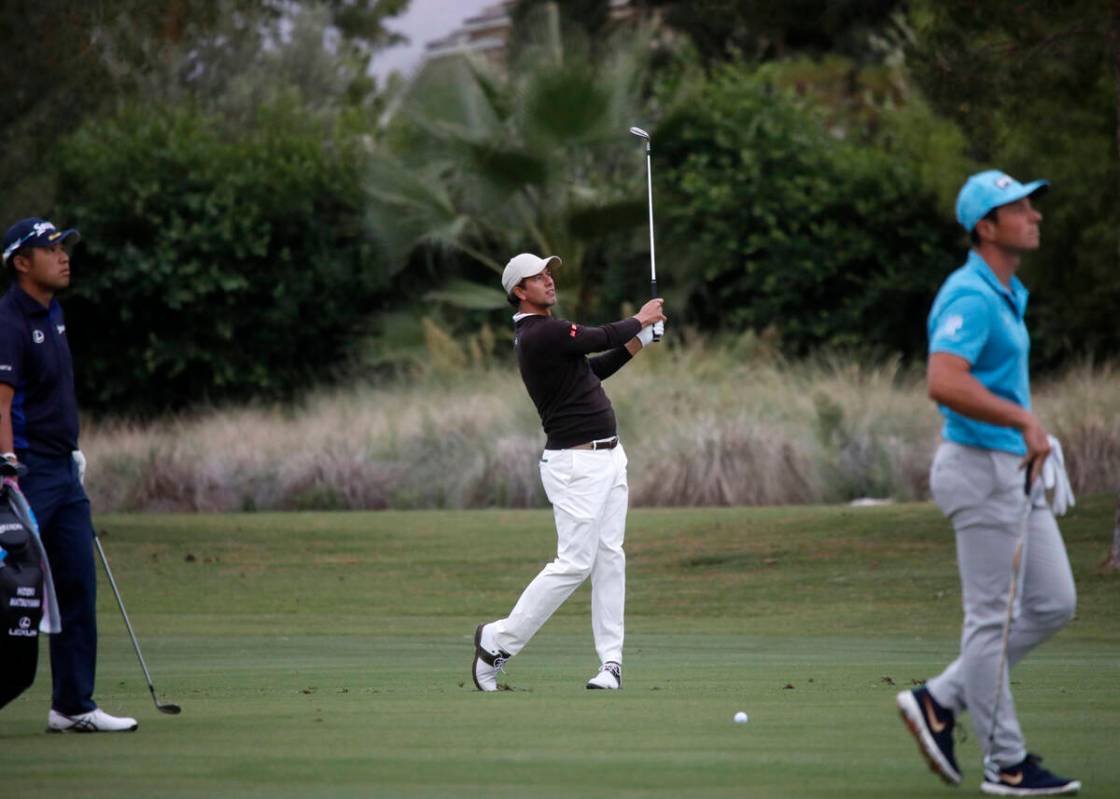 Adam Scott, center, hits from the fairway on the 10th hole during the first round of the Shrine ...