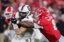South Carolina quarterback Luke Doty (4) is tackled by Georgia linebacker MJ Sherman (8) during ...