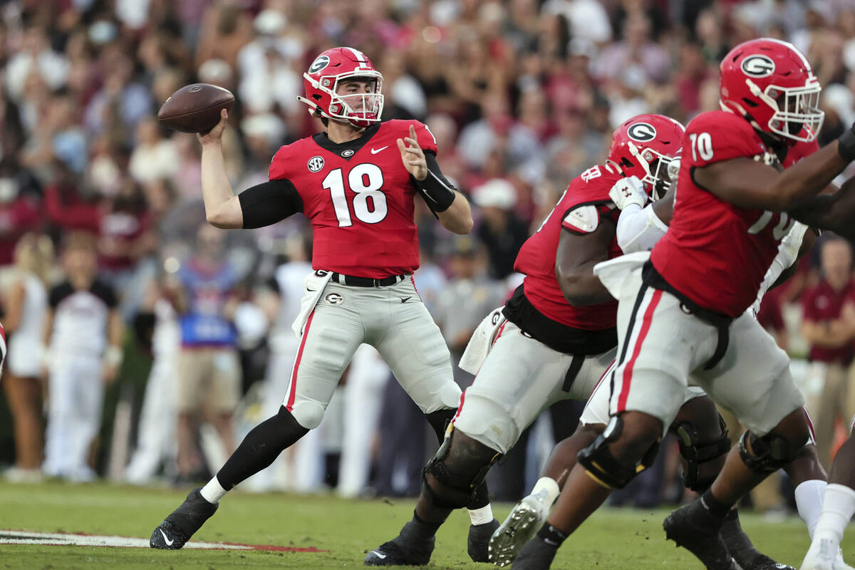 Georgia quarterback JT Daniels (18) throws a pass against South Carolina during the first half ...