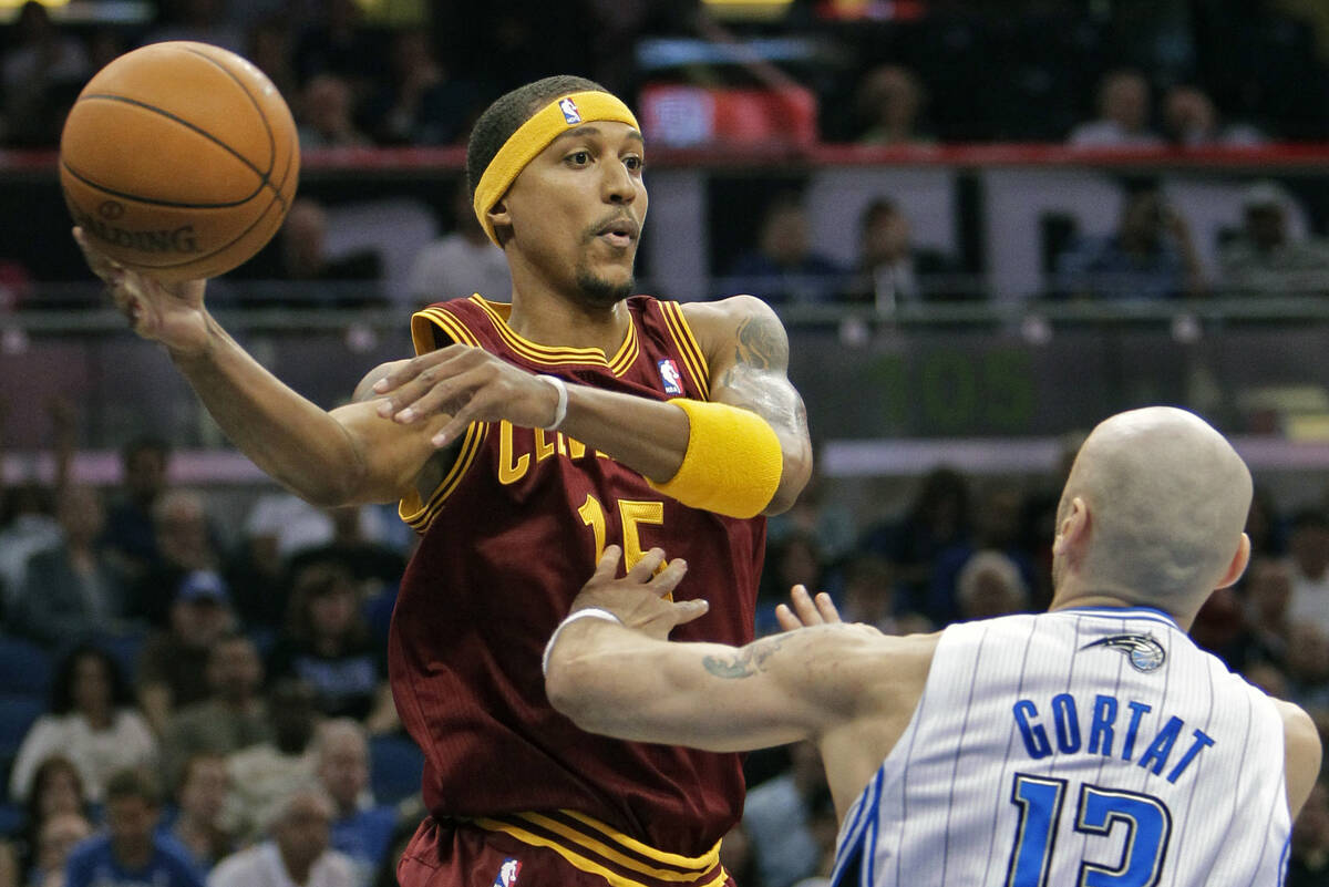 FILE - Cleveland Cavaliers' Jamario Moon, left, makes a pass over the head of Orlando Magic's M ...