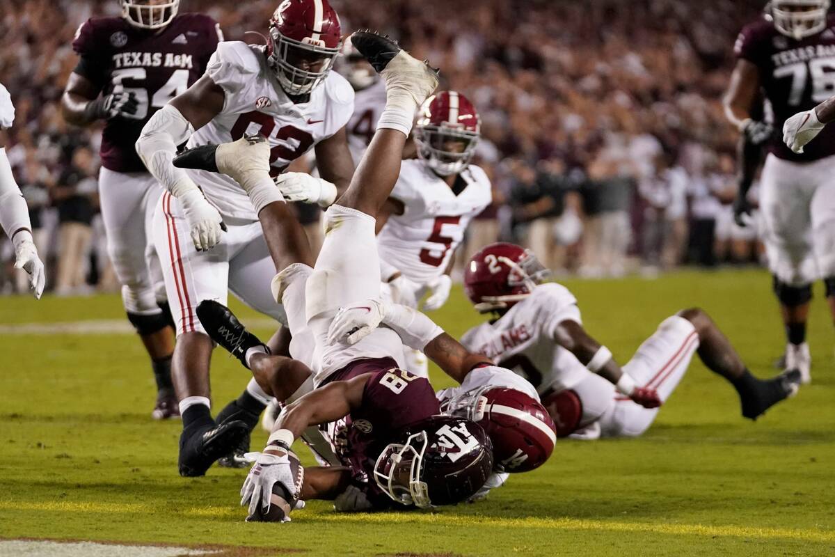 Texas A&M running back Isaiah Spiller (28) dives over the goal line for a touchdown as Alabama ...