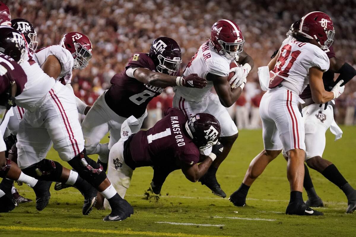 Alabama running back Brian Robinson Jr. (4) is tackled short of the goal line by Texas A&M line ...