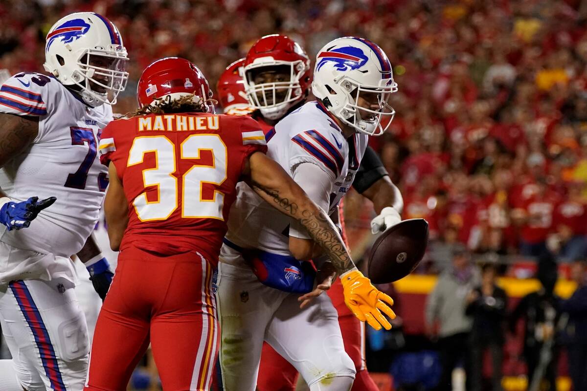Buffalo Bills quarterback Josh Allen, right, scores a touchdown as the ball is knocked away by ...