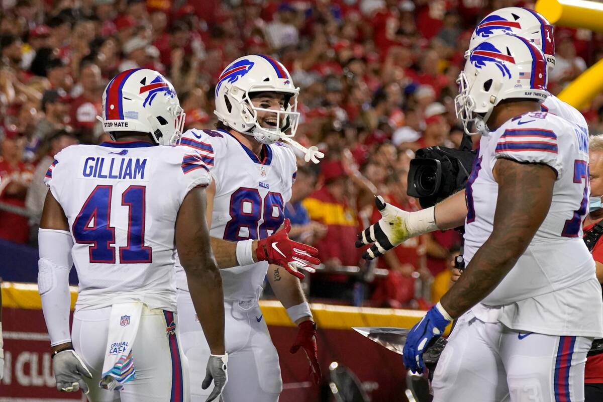 Buffalo Bills tight end Dawson Knox (88) is congratulated by teammates after scoring during the ...