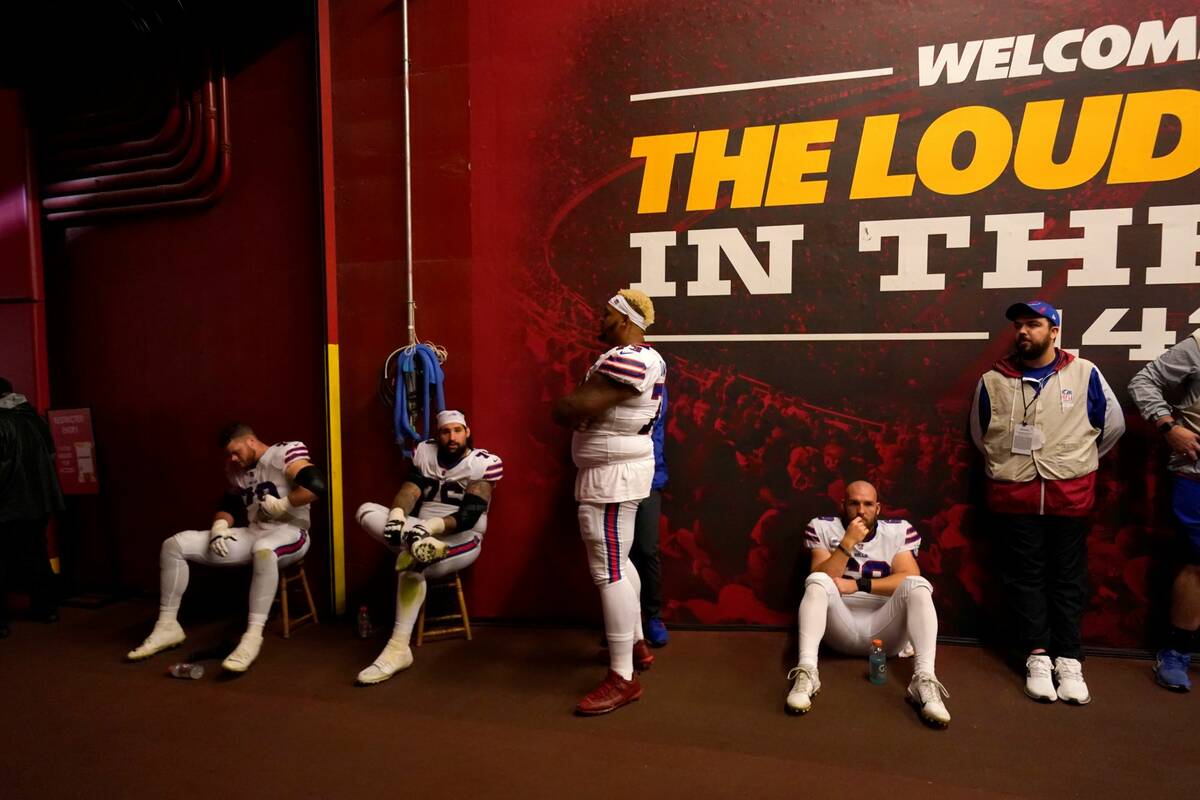 Members of the Buffalo Bills sit in a tunnel off the field as they wait for the start of the se ...