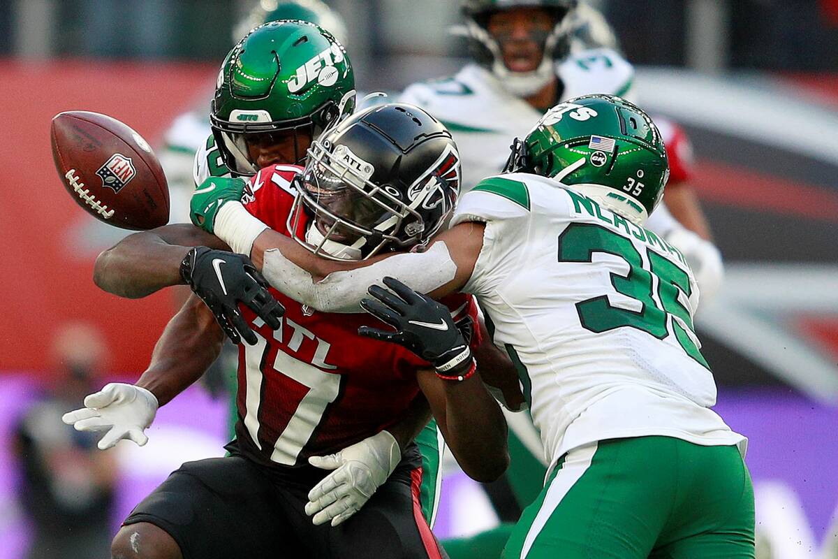 New York Jets defensive back Sharrod Neasman (35), right, tackles Atlanta Falcons wide receiver ...