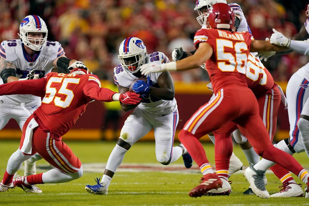 Buffalo Bills running back Devin Singletary (26) runs with the ball during the first half of an ...