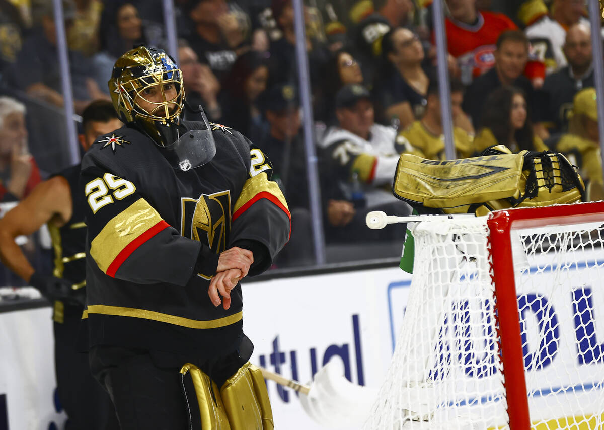 Golden Knights goaltender Marc-Andre Fleury (29) takes his gloves off during a break after givi ...