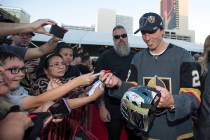 Vegas Golden Knights goaltender Marc-Andre Fleury (29), right, signs a helmet for Anthony Mora, ...