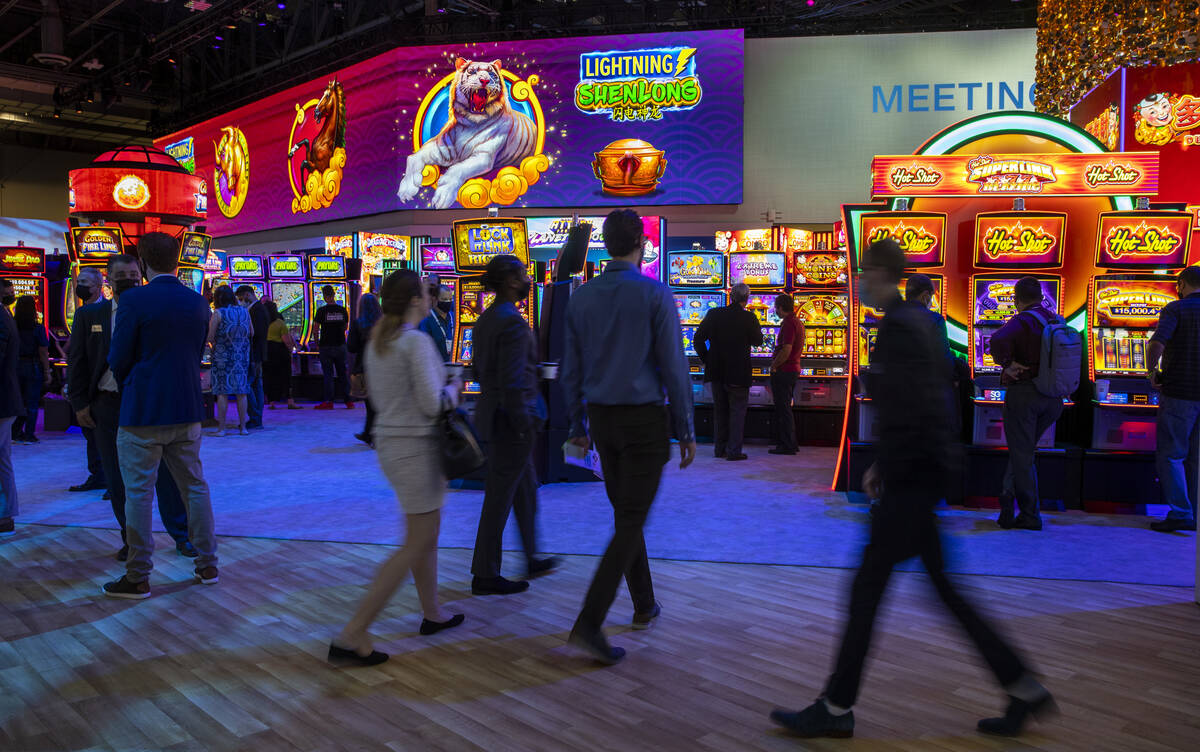 Attendees wander within the Scientific Games display area during day 4 at the Global Gaming Exp ...