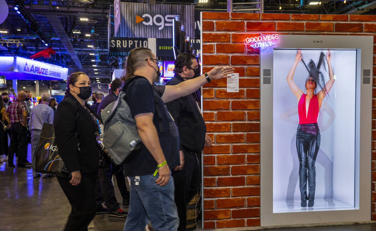 Attendees wander past a new AGS Portl hologram unit during day 3 at the Global Gaming Expo 2021 ...