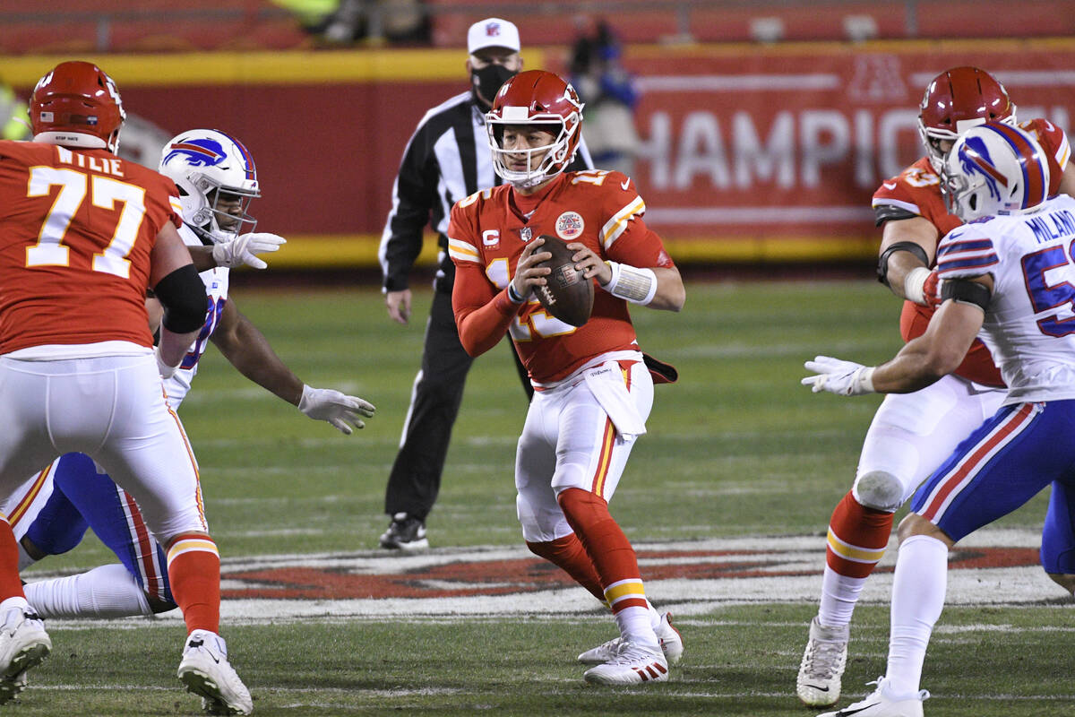 Kansas City Chiefs quarterback Patrick Mahomes scrambles during the first half of the NFL AFC c ...