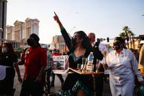 Cristina Kline chants as she marches with other members of the Culinary Workers Union Local 226 ...