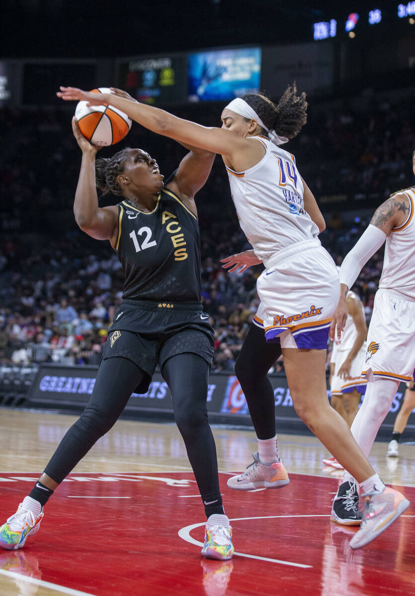 Las Vegas Aces guard Chelsea Gray (12) looks to shoot past Phoenix Mercury guard Bria Hartley ( ...