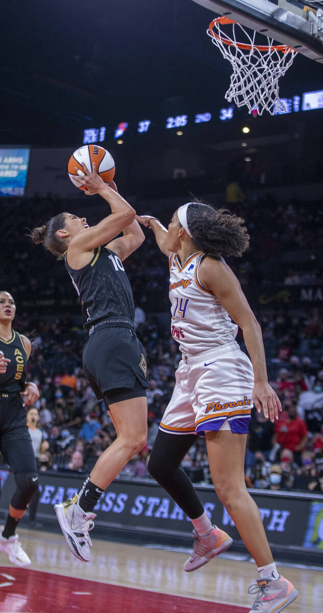 Las Vegas Aces guard Kelsey Plum (10) shoots over Phoenix Mercury guard Bria Hartley (14) durin ...