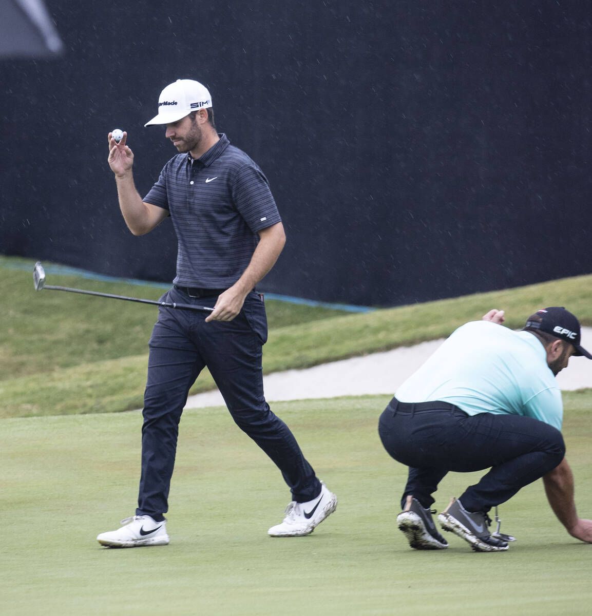 Matthew Wolff, left, of Agoura Hills, Calif., reacts after a putt on the 18th hole as Francesco ...