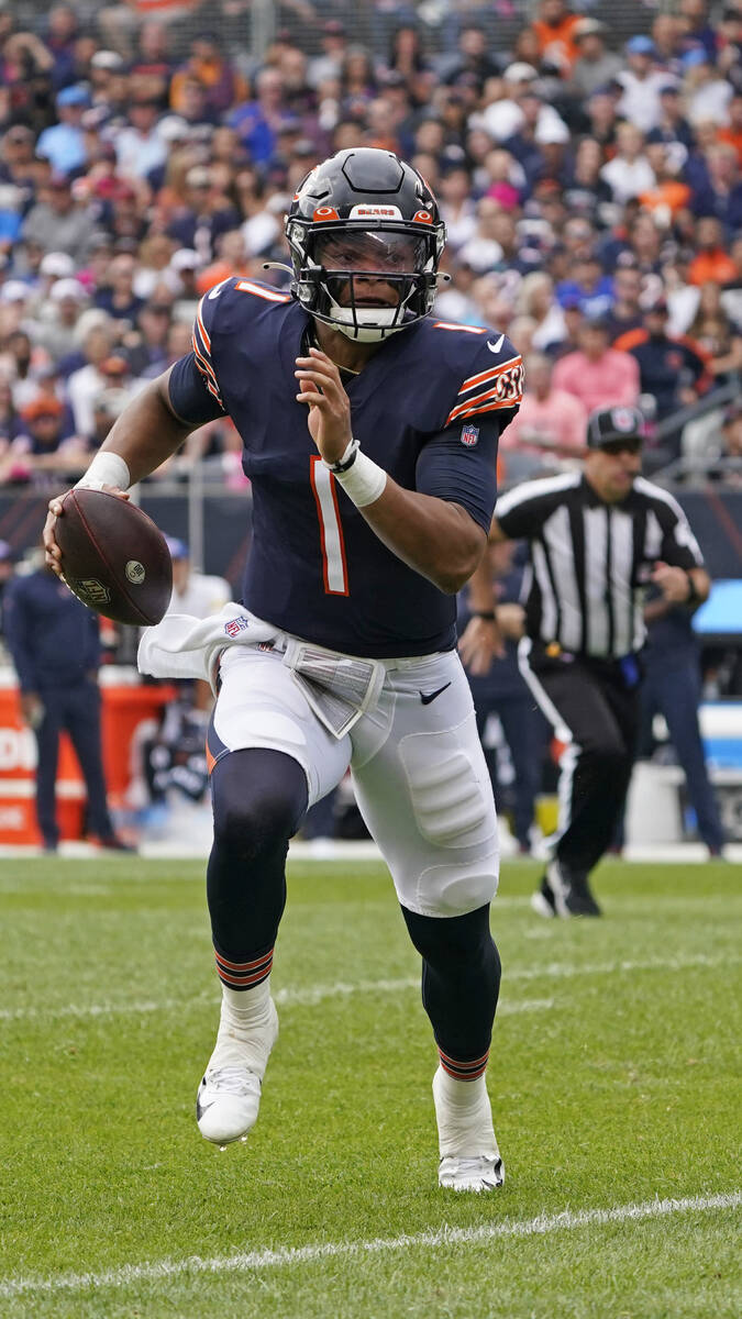 Chicago Bears quarterback Justin Fields (1) runs against the Detroit Lions in the first half du ...