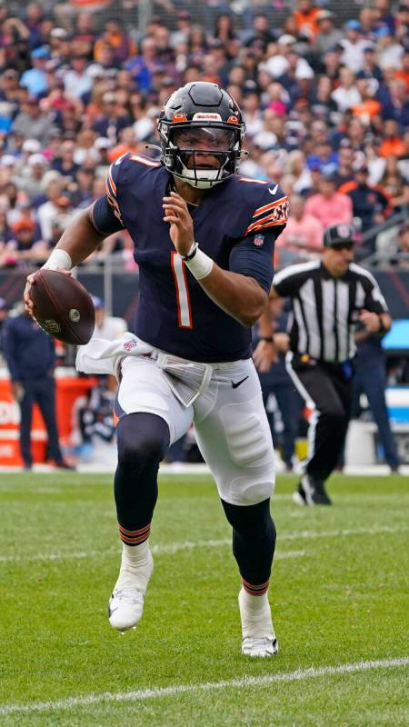 Chicago Bears quarterback Justin Fields (1) runs against the Detroit Lions in the first half du ...