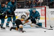 Vegas Golden Knights right wing Evgenii Dadonov (63) battles for the puck against San Jose Shar ...