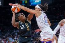 Las Vegas Aces guard Chelsea Gray (12) looks to shoot past Phoenix Mercury guard Bria Hartley ( ...