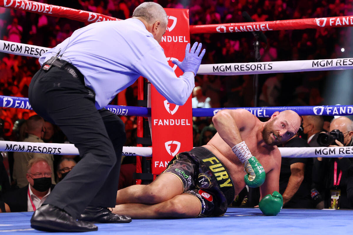 Tyson Fury is knocked down by Deontay Wilder in the fourth round of a WBC Heavyweight World Cha ...