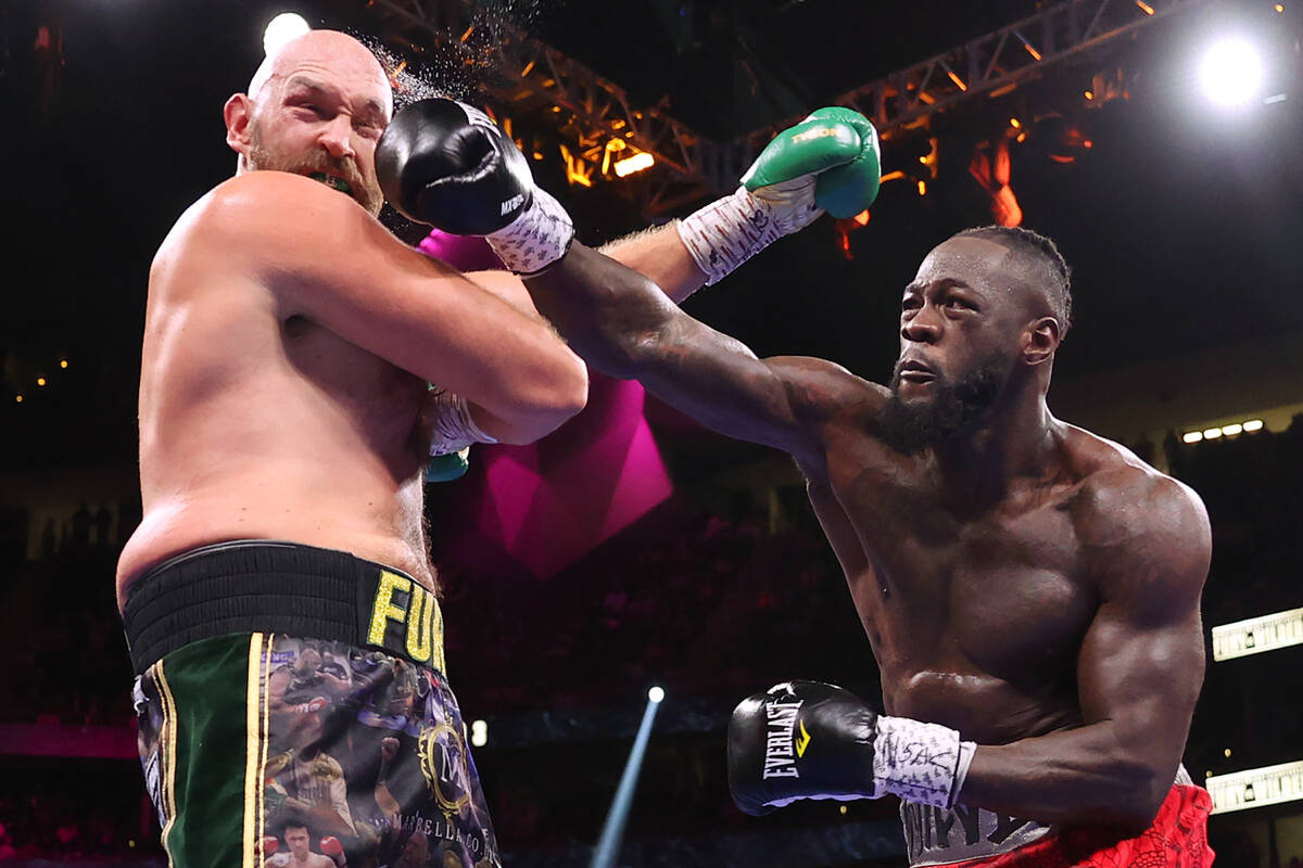 Deontay Wilder, right, connects a punch against Tyson Fury in the third round of a WBC Heavywei ...