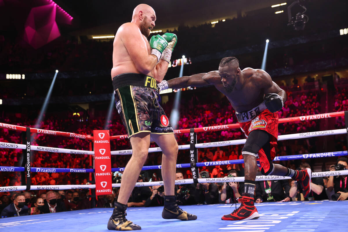 Deontay Wilder, right, throws a punch a punch against Tyson Fury in the third round of a WBC He ...