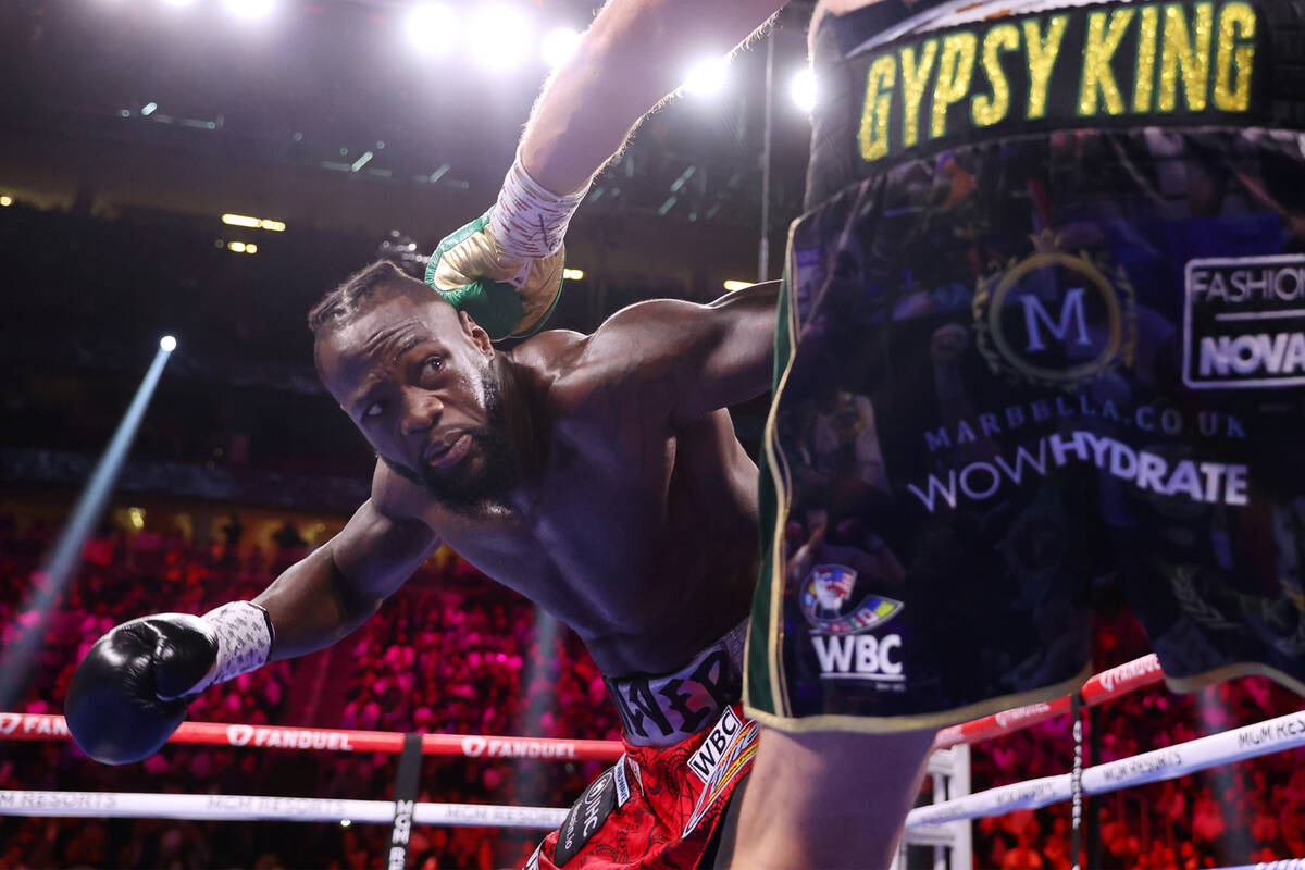 Deontay Wilder, left, and Tyson Fury, battle in the first round of a WBC Heavyweight World Cham ...