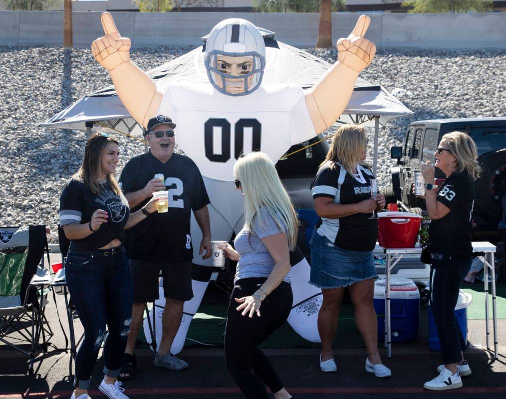 The Raiders fans Dani Buckley, left, and Lenette Reece of Las Vegas dance outside of Allegiant ...