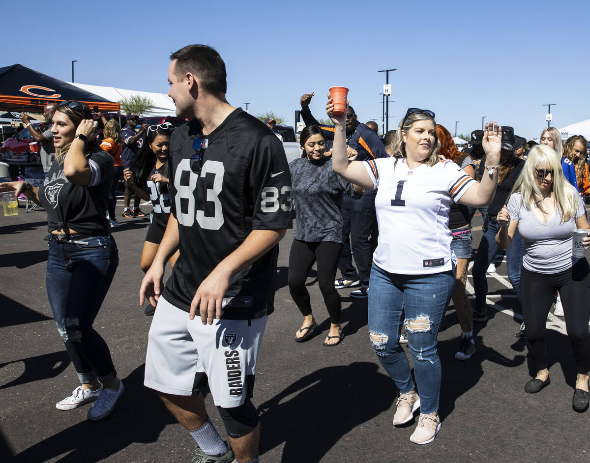 Chicago BearsÕ fans and Raiders fans dance outside of Allegiant Stadium prior to an NFL fo ...