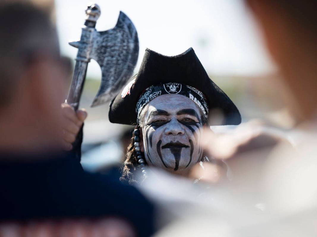 Raiders fan Michael Machado of Chino Hills, Calif., watches as Chicago Bears fans walk past him ...