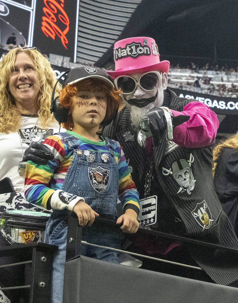 Raiders fans pose during the first quarter of an NFL football game against the Chicago Bears on ...