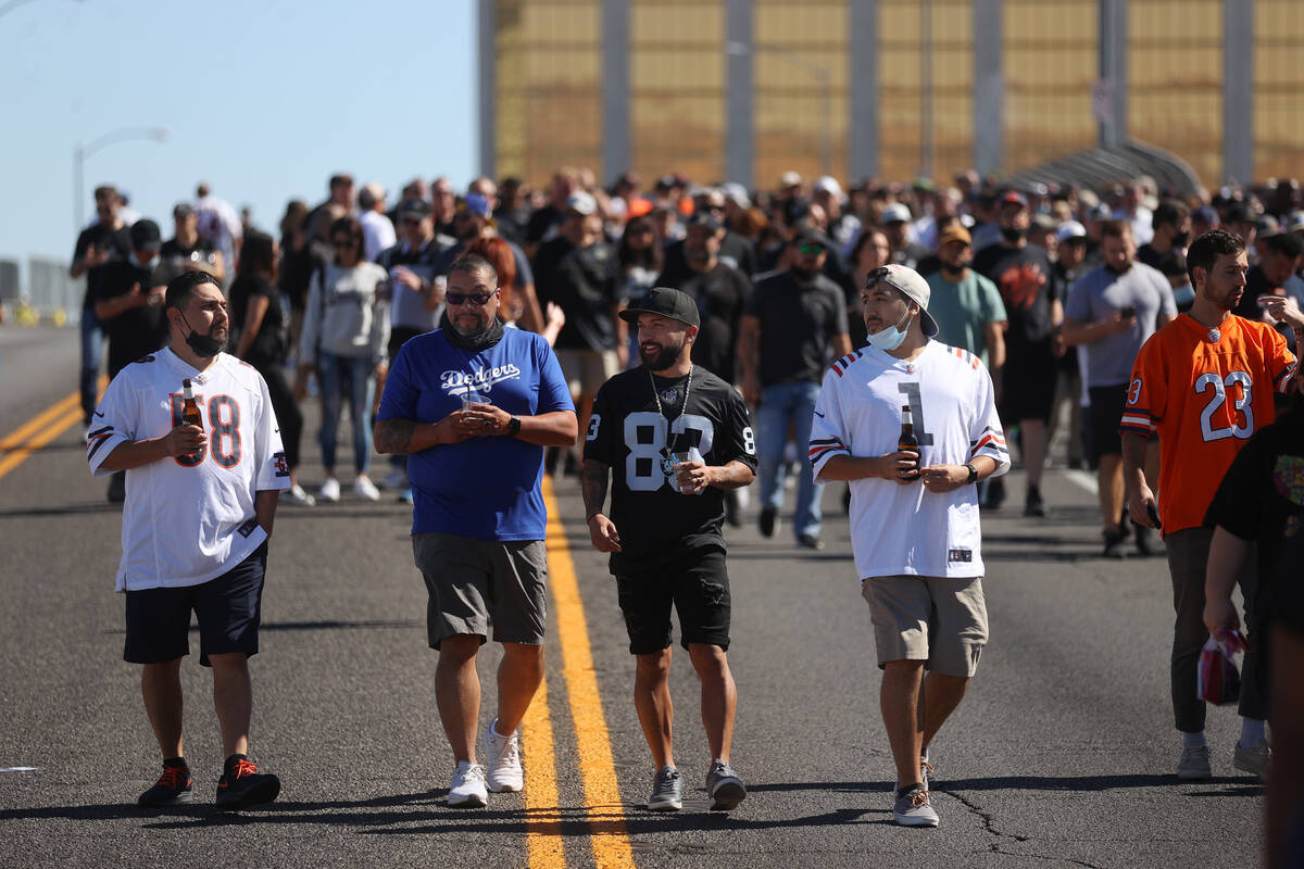 Fans make their way to Allegiant Stadium in Las Vegas from the Hacienda before the start of an ...