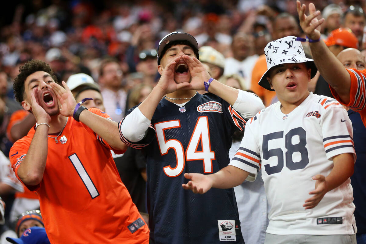 Chicago Bears fans cheer on their team during the second half of an NFL football game against t ...