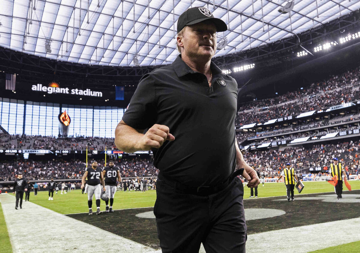 Raiders head coach Jon Gruden jogs off the field after an NFL football game against the Chicago ...