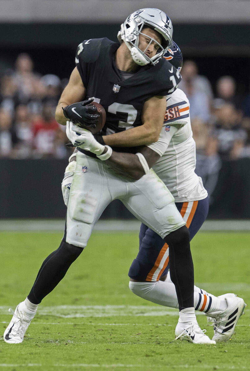 Raiders wide receiver Hunter Renfrow (13) is tackled by Chicago Bears free safety Eddie Jackson ...