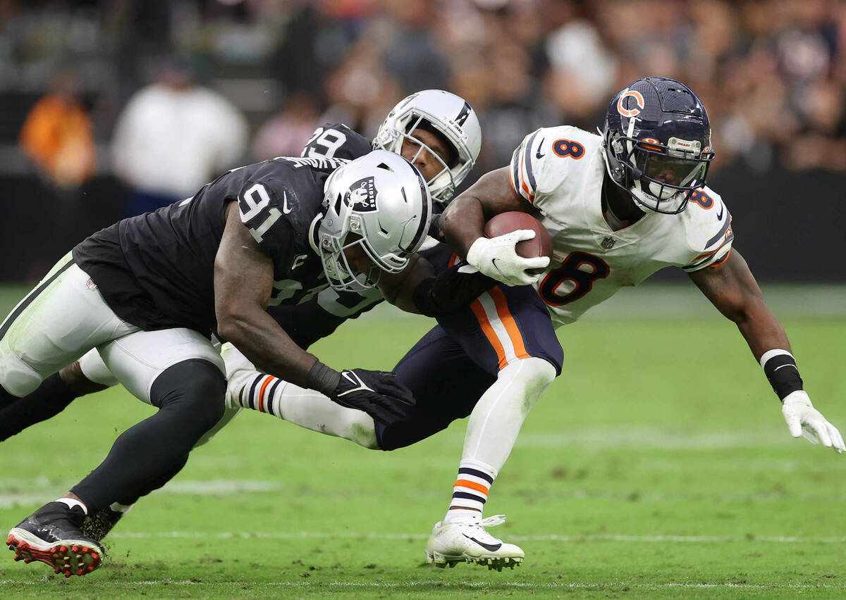 Chicago Bears running back Damien Williams (8) is tackled by Raiders defensive end Yannick Ngak ...
