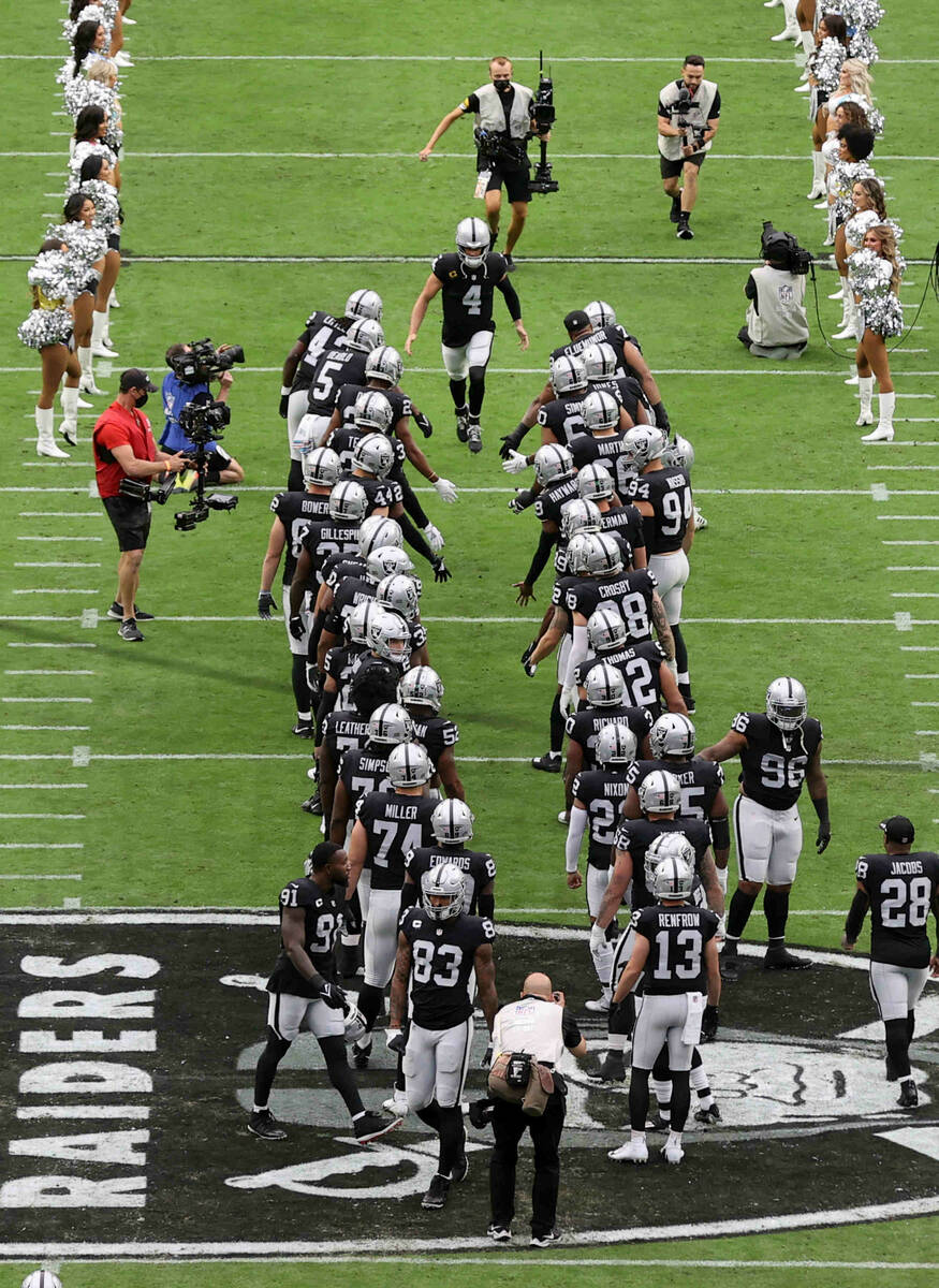 Quarterback Derek Carr takes the field as the Raiders prepare to take on the Chicago Bears at A ...