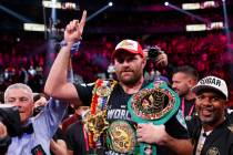 Tyson Fury, of England, celebrates after defeating Deontay Wilder in a heavyweight championship ...