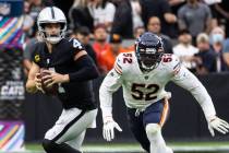 Raiders quarterback Derek Carr (4) chased by Chicago Bears outside linebacker Khalil Mack (52) ...