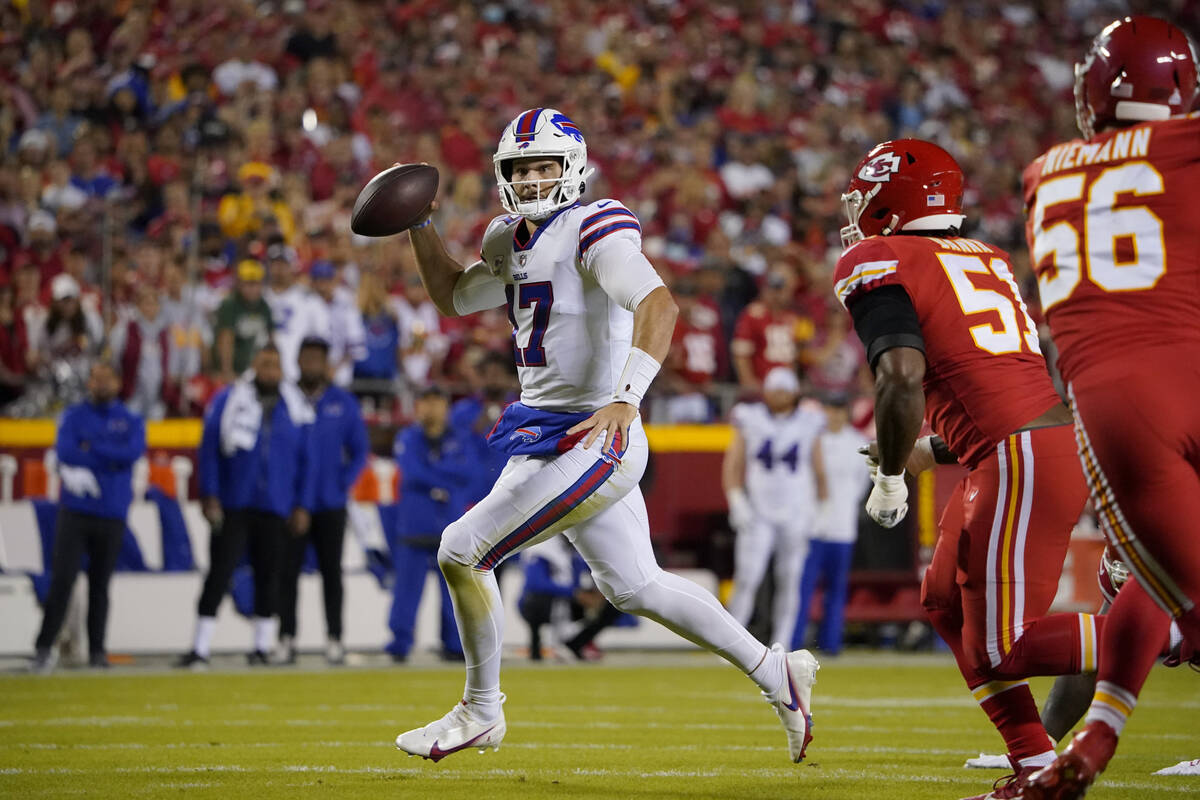 CORRECTS TO RUNS FOR A FIRST DOWN NOT A TOUCHDOWN - Buffalo Bills quarterback Josh Allen, left, ...