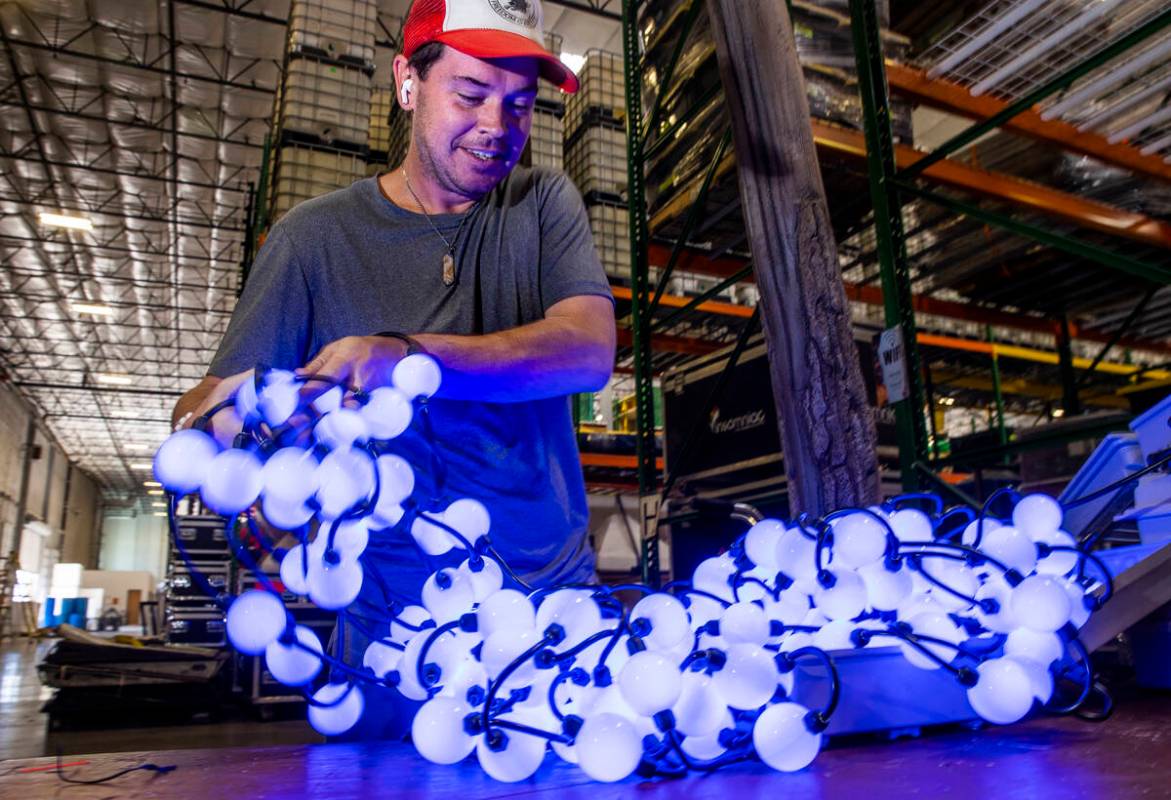 Mark Weathers with Ultimate Lighting inspects numerous strands of lights to be used for backdro ...