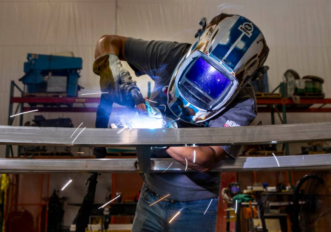 Oliver Garcia spot welds some set framing within the Electric Daisy Carnival warehouse on Thurs ...
