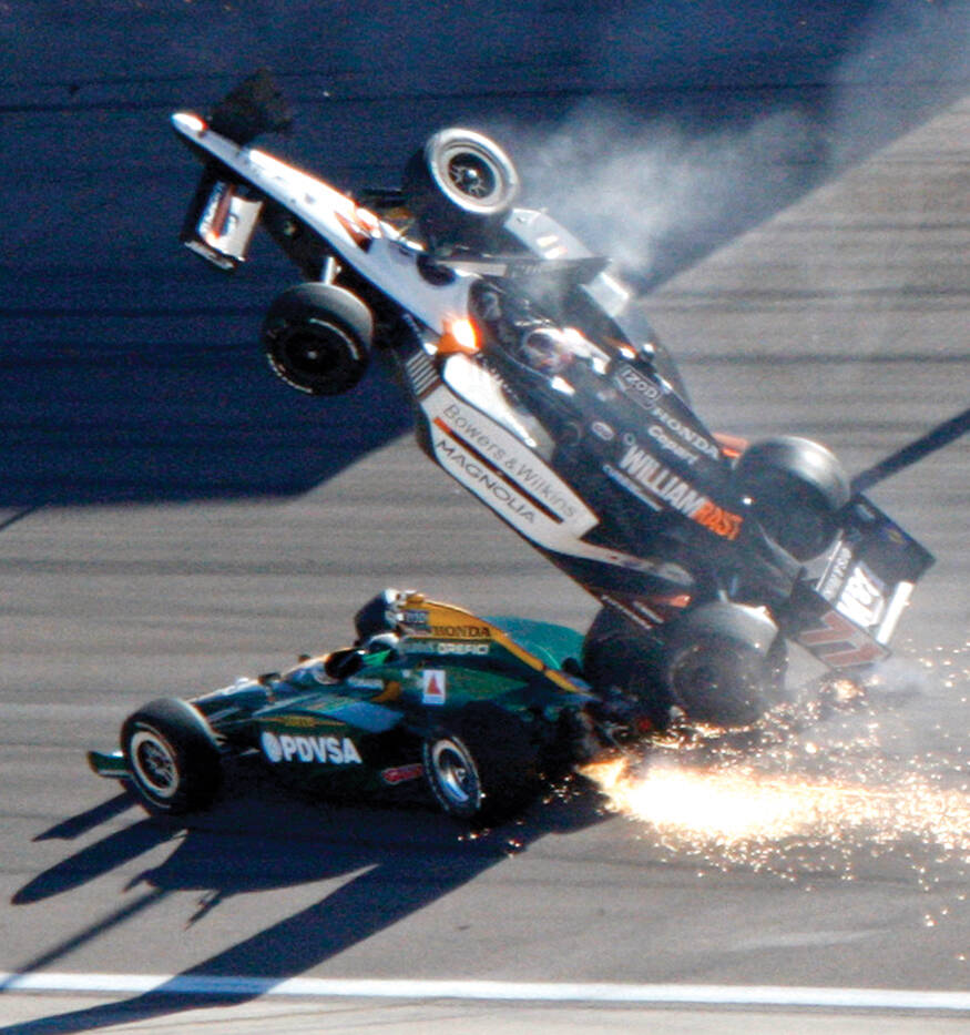 Dan Wheldon (77) goes airborne during a wreck that involved 15 cars in the IndyCar Series' Las ...