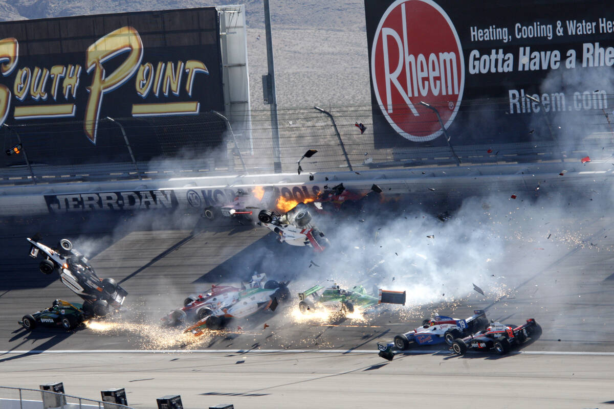 IndyCar race cars come apart as they spin, bump, crash and fly through the air as a tightly pac ...