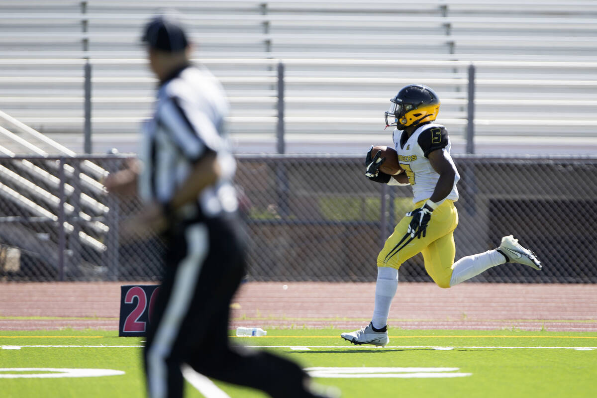 Clark running back D'on Williams (5) runs toward the end zone for a touchdown against Cheyenne ...