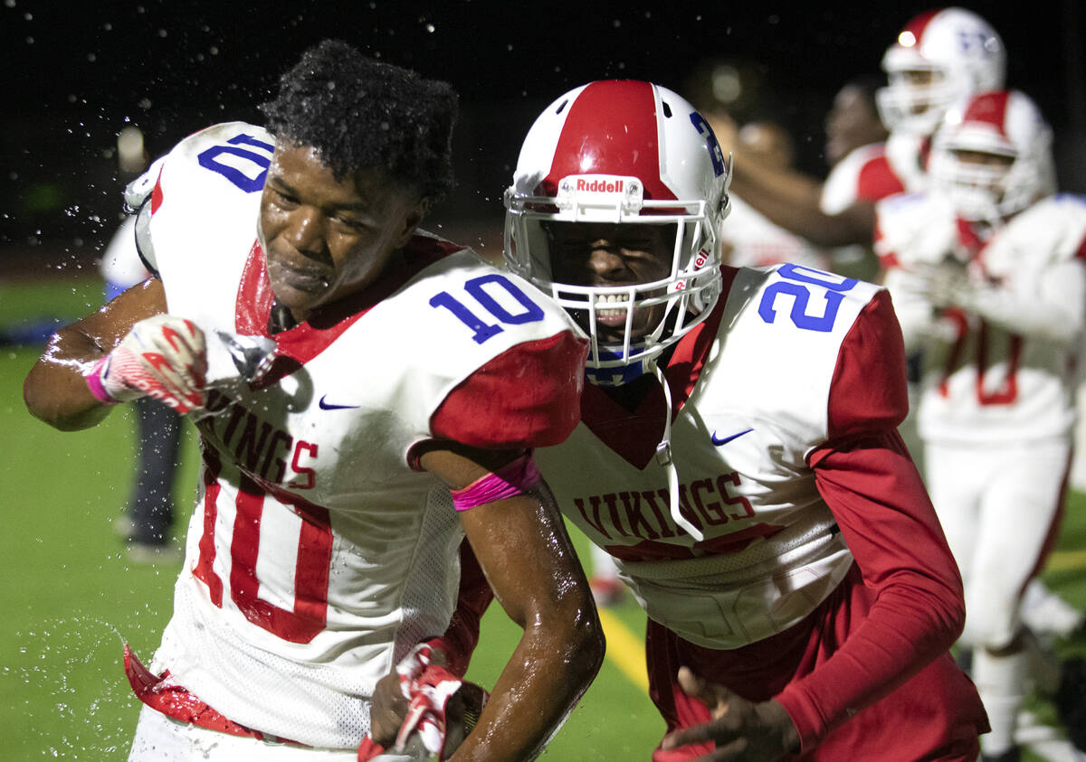 Valley's Jakauri Hawkins (20) runs to embrace his teammate DeAndre Gholar (10), who helped lead ...