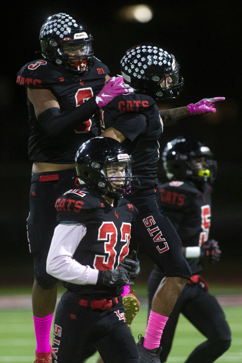 Las Vegas' Adonis Edwards-Jackson (3) and Stephan Hunt (6) jump to celebrate an interception wh ...